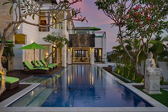 Pool and villa at dusk